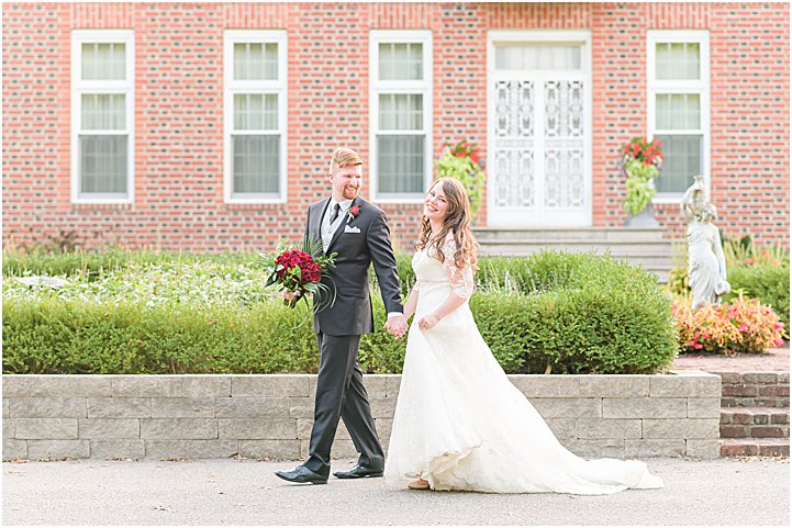Bride and groom walking and smiling Coxhall Gardens anniversary session