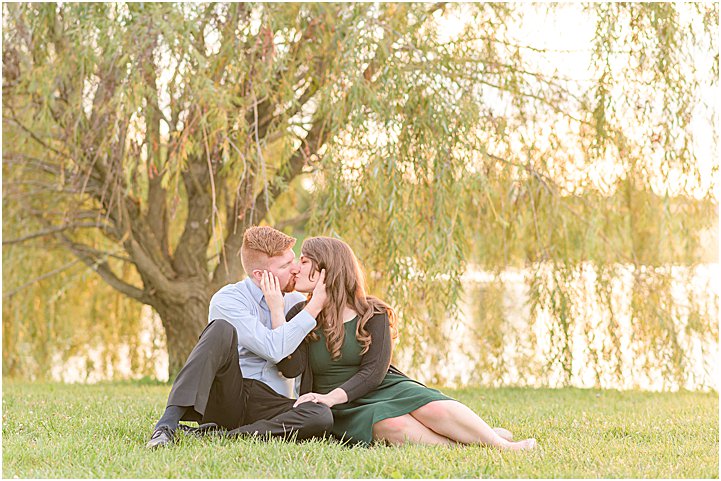 Couple sitting and kissing Coxhall Gardens anniversary session
