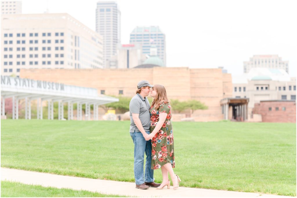 Couple nose to nose in front of Indianapolis skyline Downtown Indianapolis Canal Engagement Session
