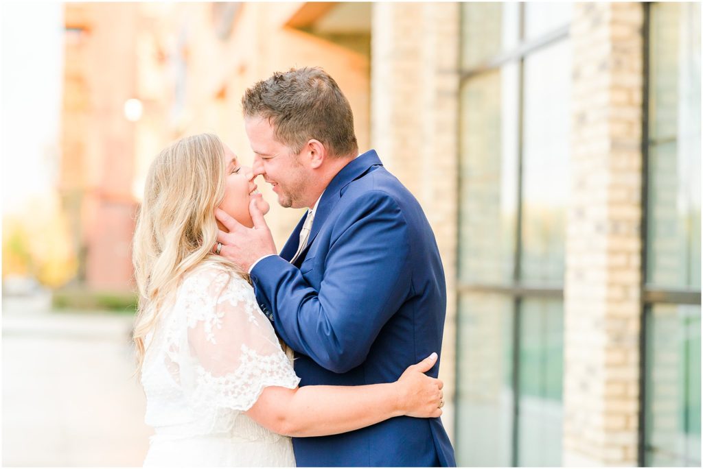 Bride and groom laughing kiss Ironworks Hotel Elopement