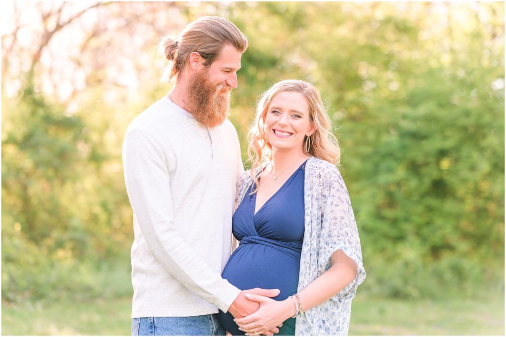 Couple smiling and cradling baby bump Province Park Maternity Session