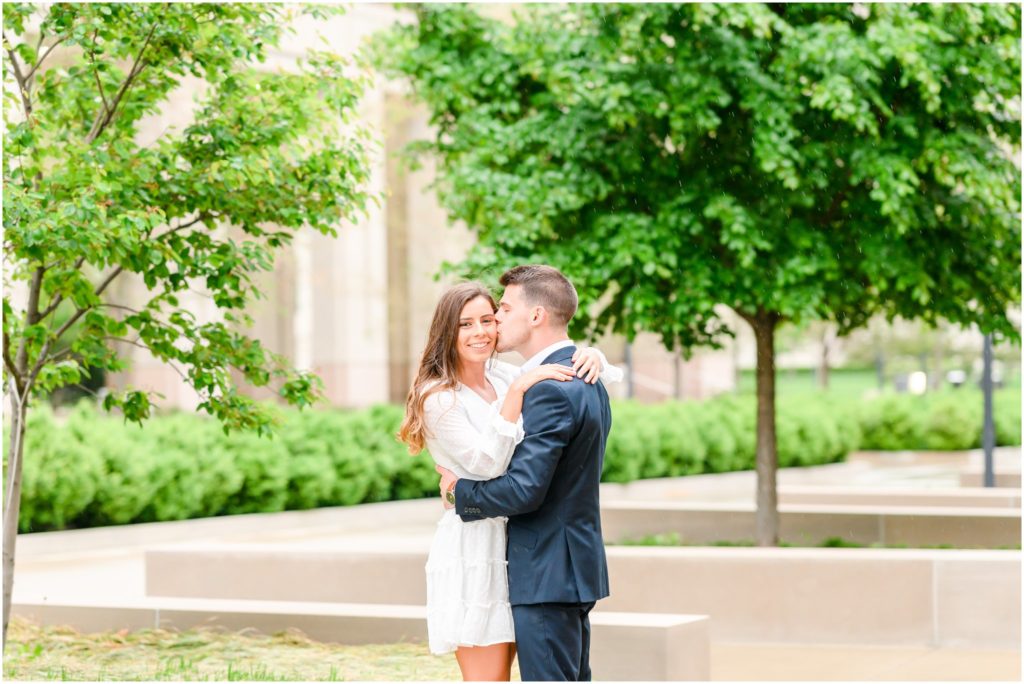 Cheek kiss downtown Indianapolis canal engagement session