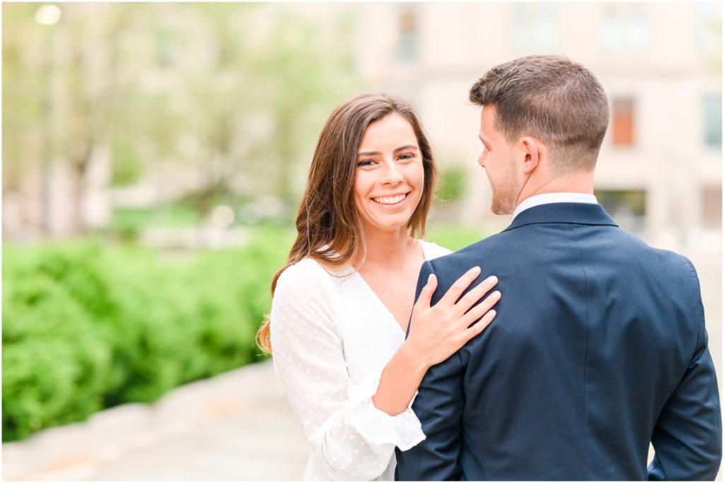 Couple laughing together downtown Indianapolis canal engagement session