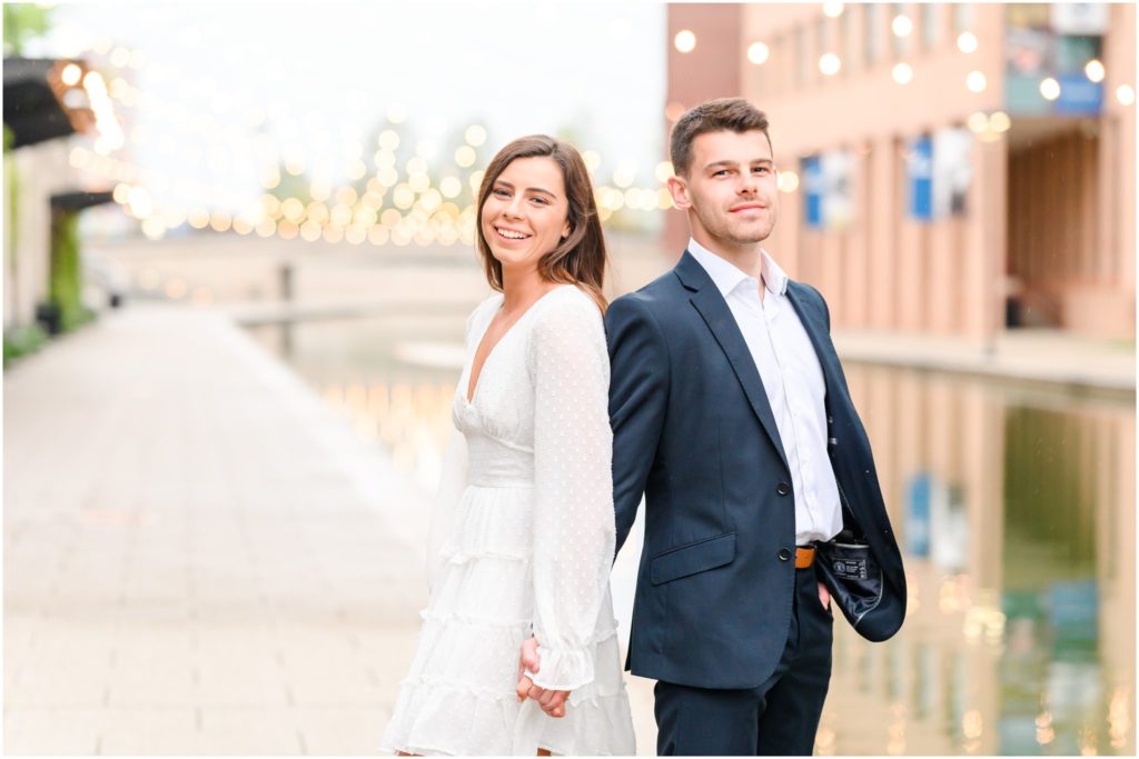 Couple laughing at camera downtown Indianapolis canal engagement session