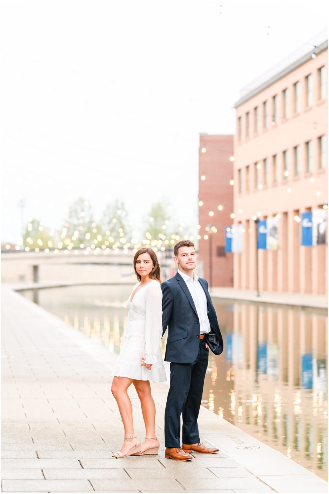 Couple model face downtown Indianapolis canal engagement session