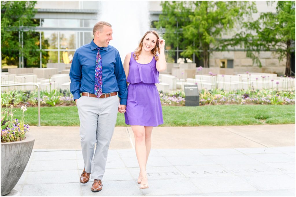Couple laughing and walking Newfields engagement session