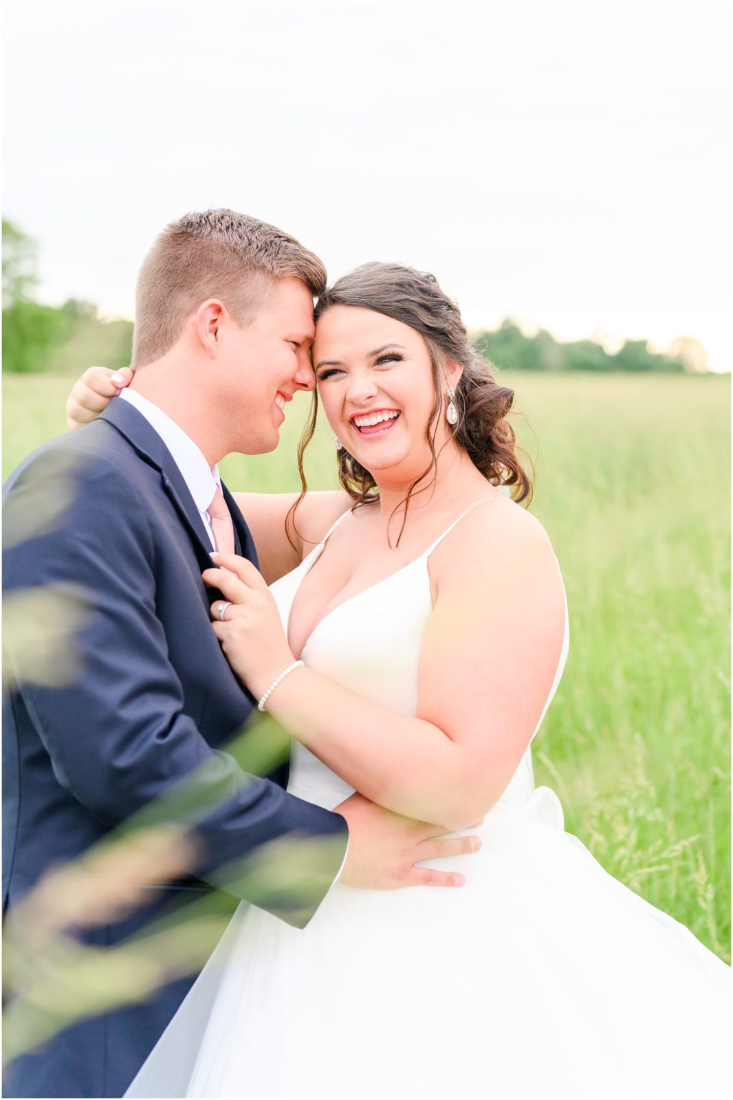 Bride and groom nuzzling and laughing Loogootee Indiana summer wedding