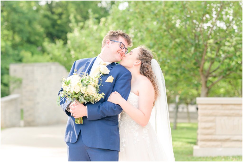 Bride and groom cheek kiss White Chapel Rose Hulman Wedding
