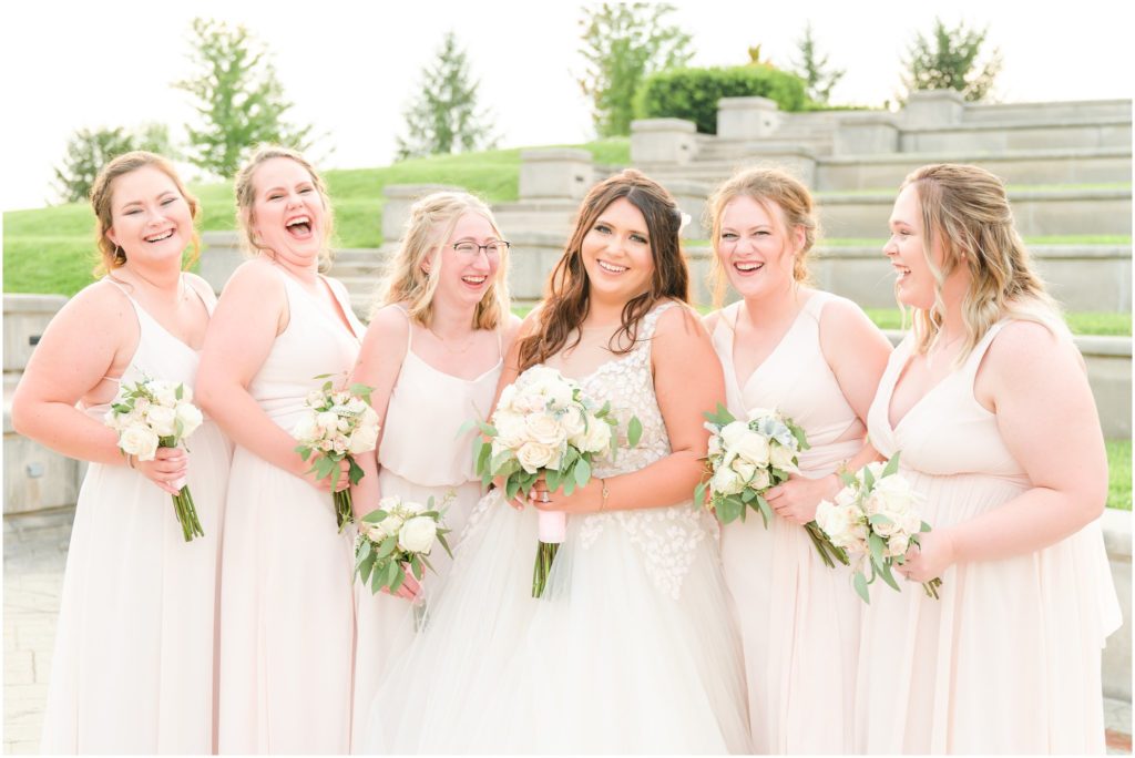 Bridesmaids laughing together Coxhall Gardens summer wedding