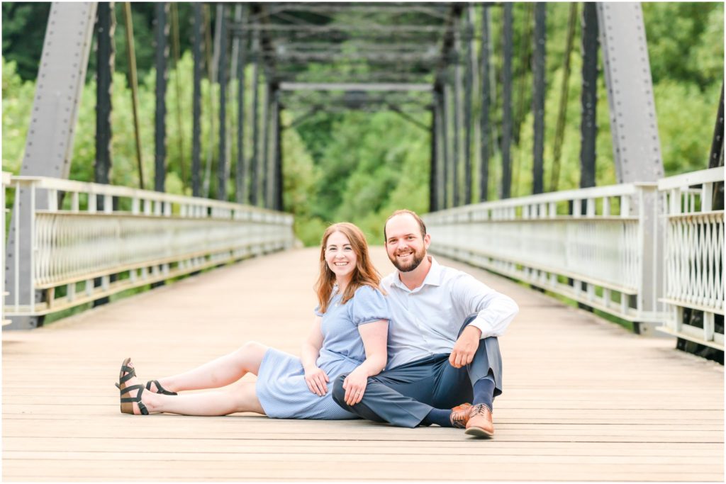 Couple sitting and smiling at camera Charlestown State Park engagement session