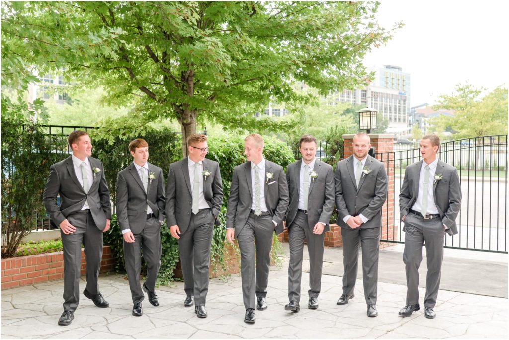 Groom and groomsmen walking and laughing together Mavris Arts & Event Center Wedding