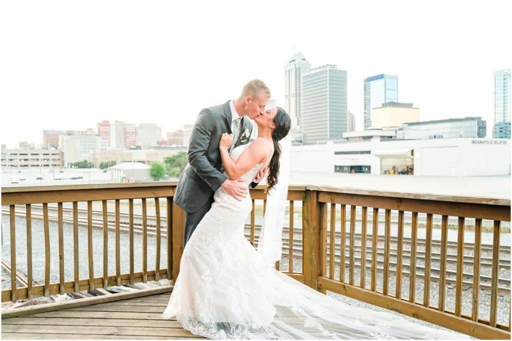 Dip kiss in front of Indianapolis skyline Mavris Arts & Event Center Wedding
