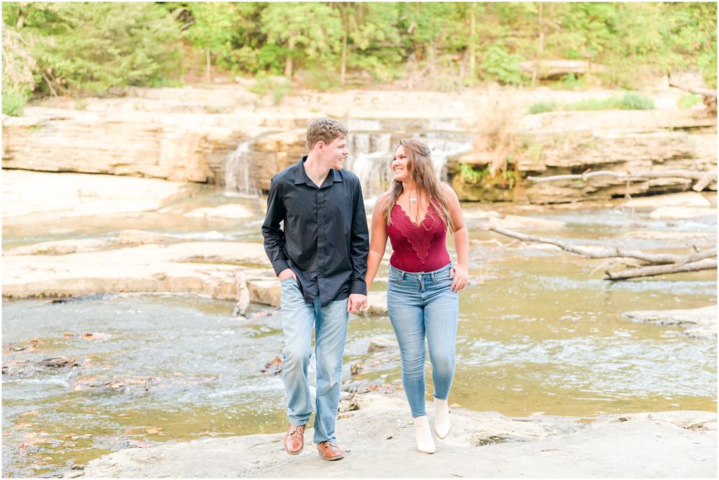 Couple walking and laughing Cataract Falls engagement session