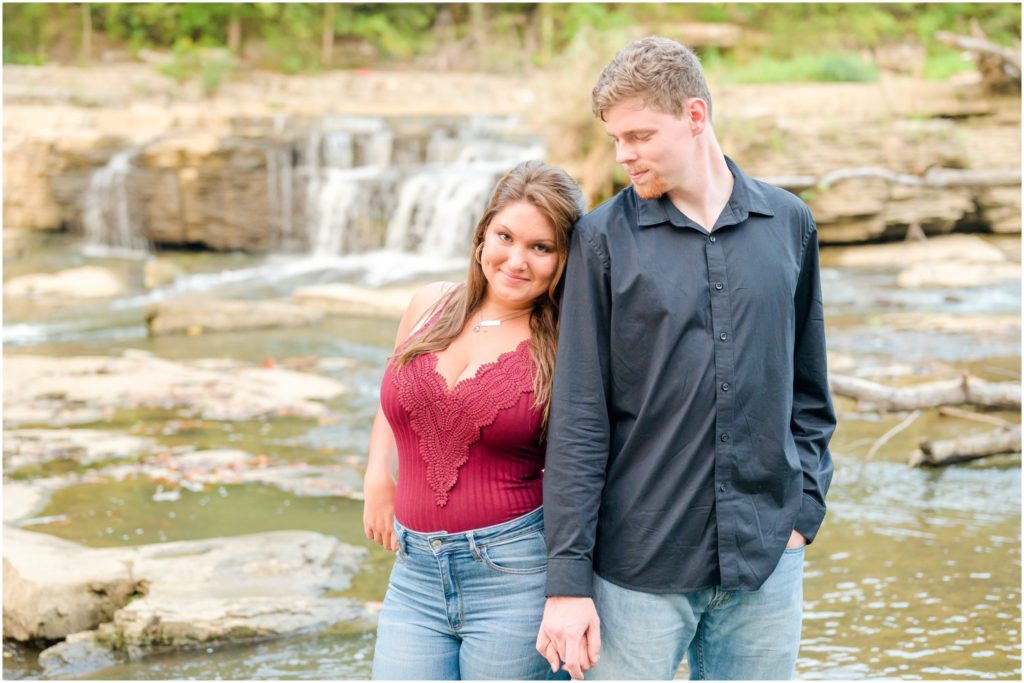 Couple nuzzling as they stand in water Cataract Falls engagement session