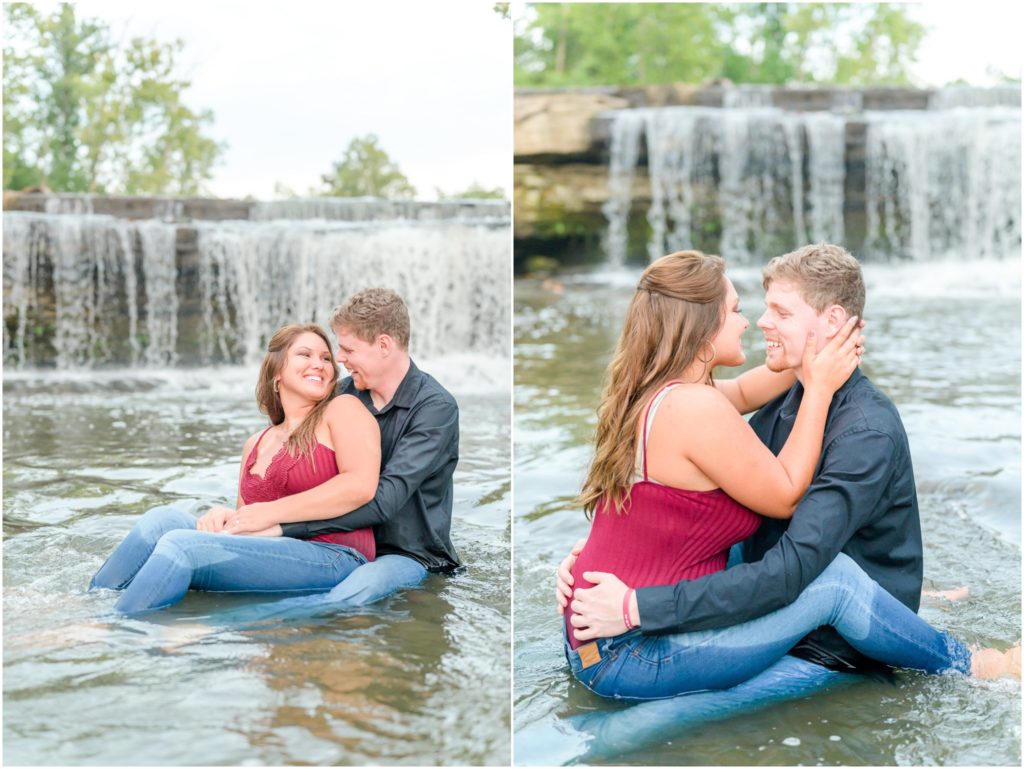 Couple laughing and sitting in water Cataract Falls engagement session