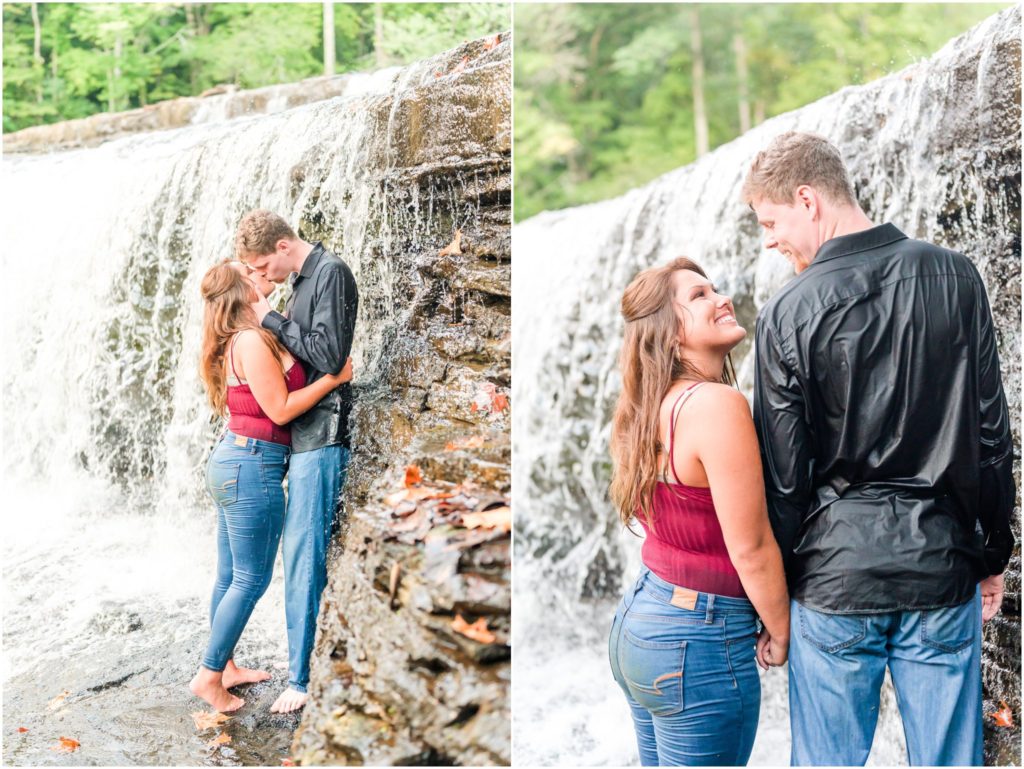 Couple kissing under waterfall Cataract Falls engagement session