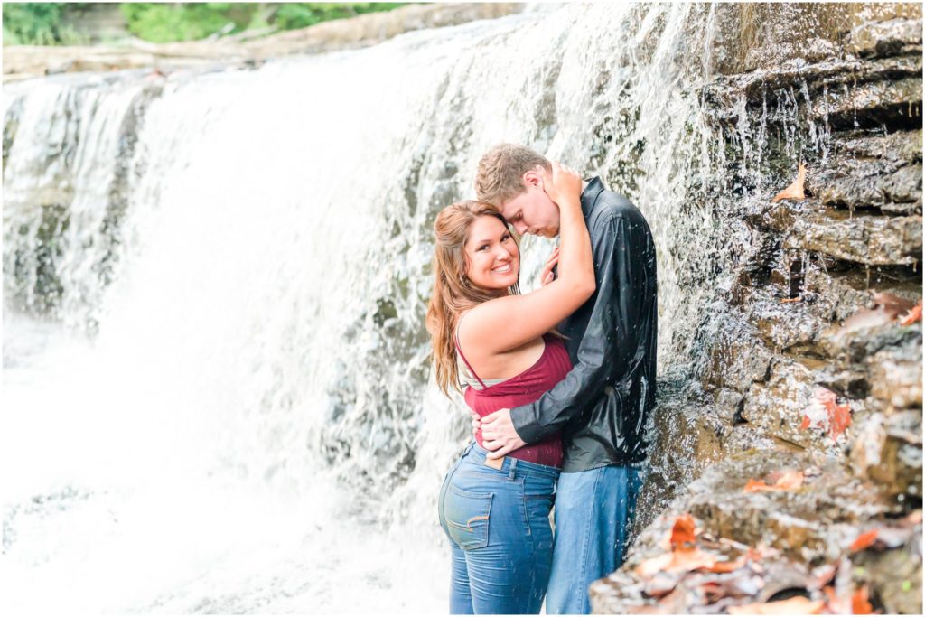 Couple nuzzling in waterfall Cataract Falls engagement session