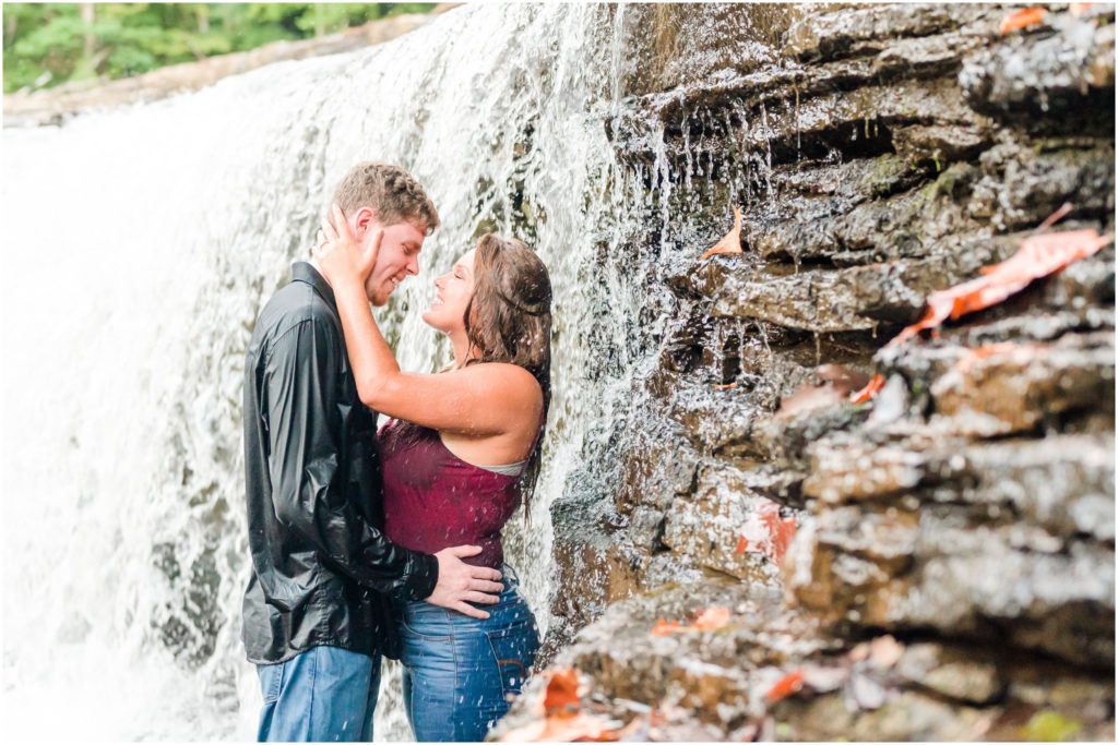 Couple laughing together in waterfall Cataract Falls engagement session