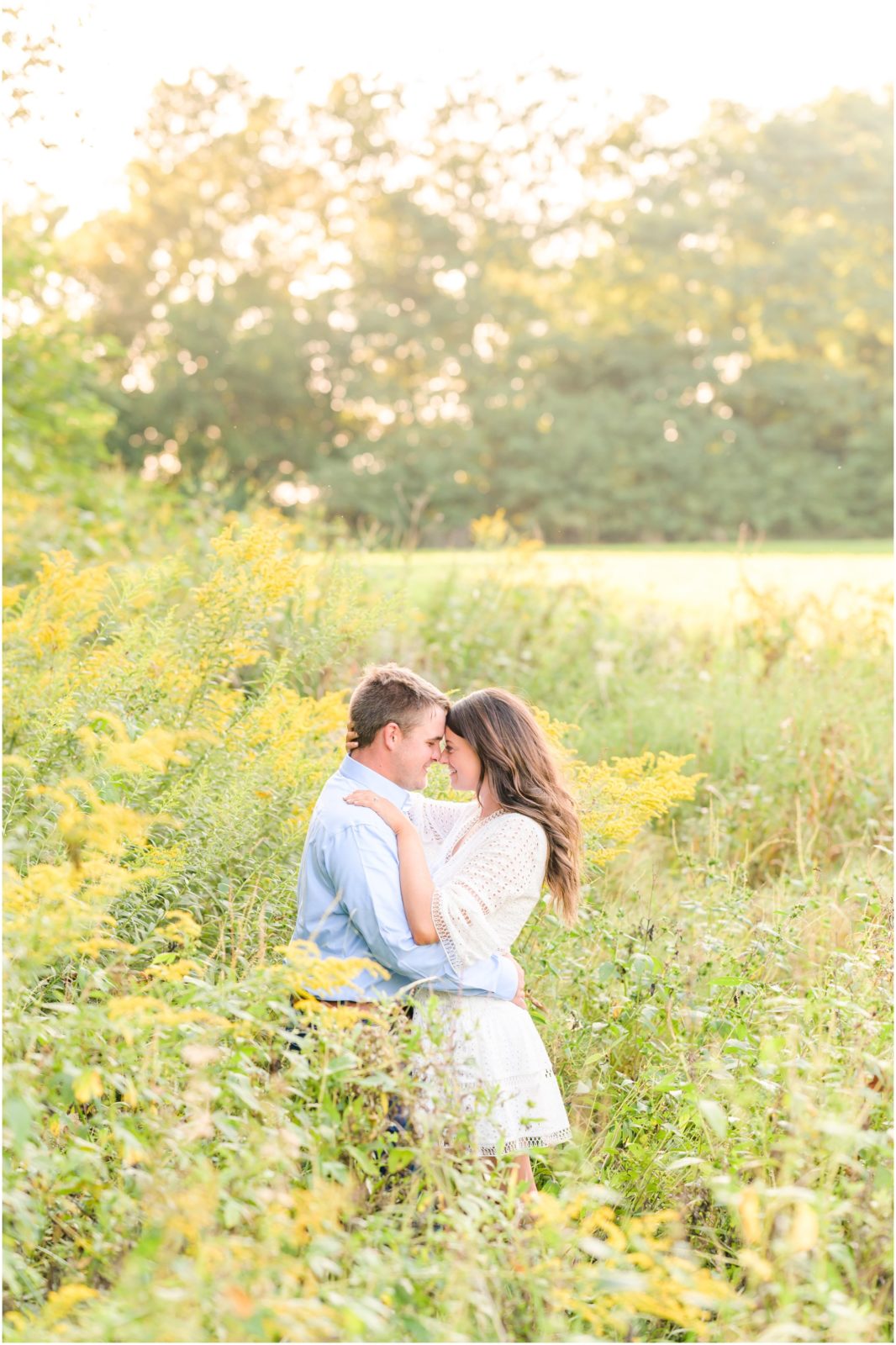 Couple nose to nose in field New Castle Indiana engagement session