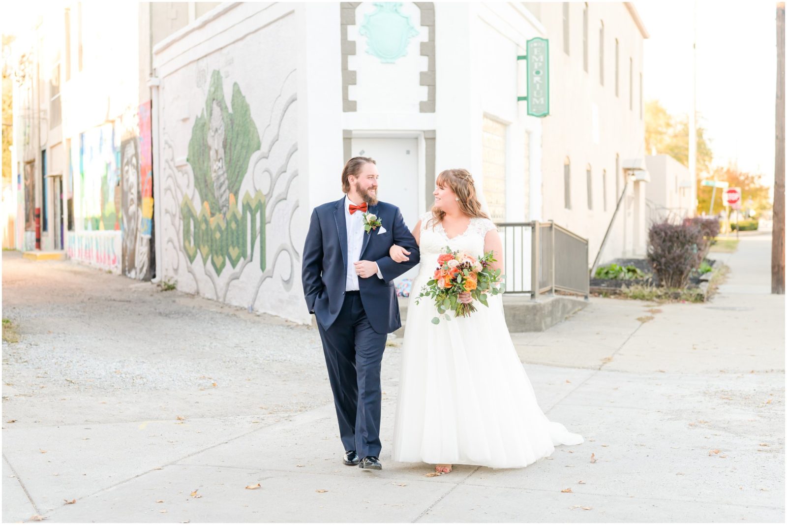Bride and groom walking and smiling together Fountain Square Theatre wedding