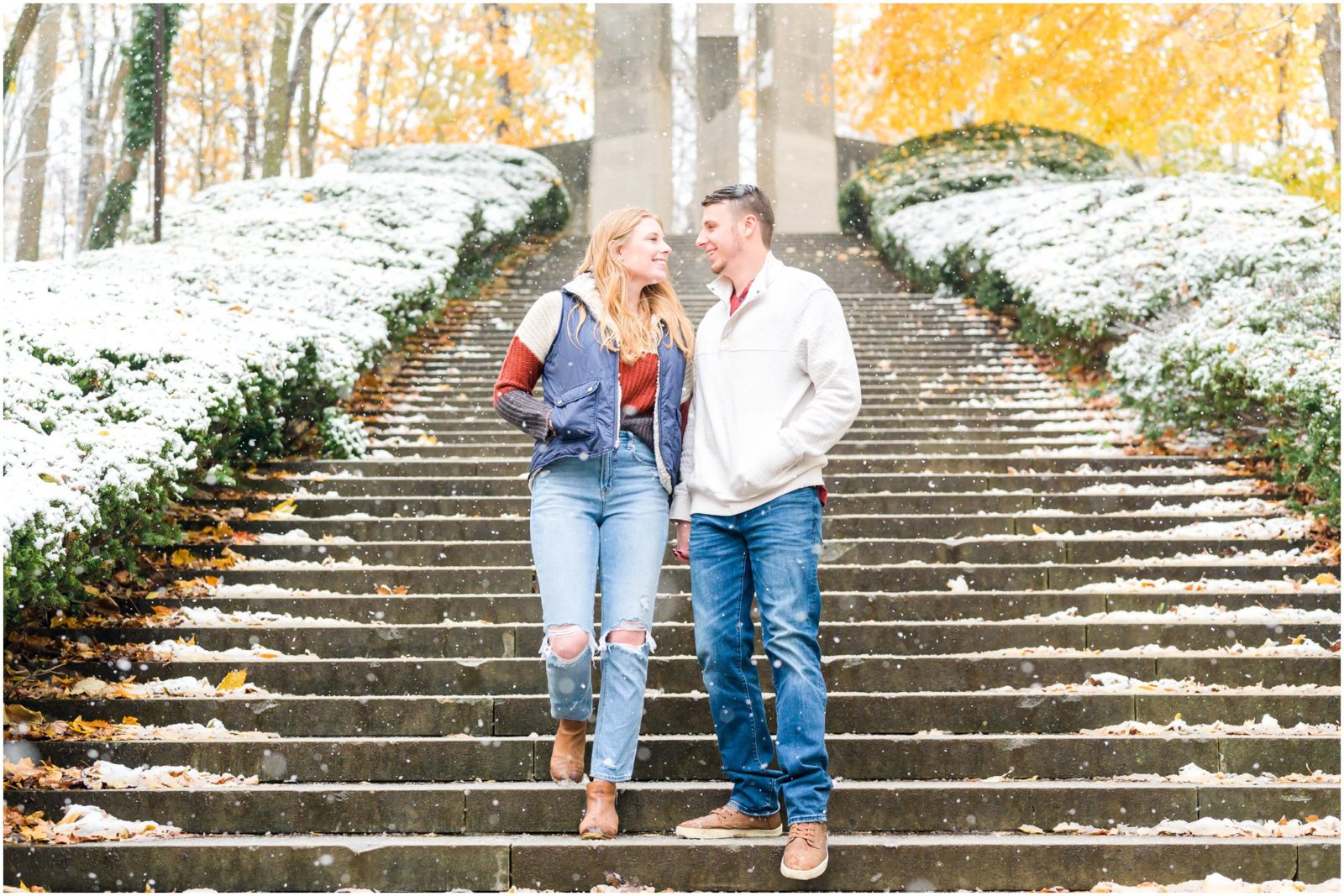 Couple walking down stairs Holcomb Gardens engagement session in the snow