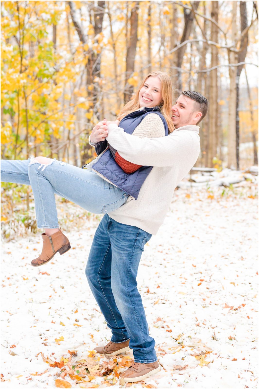 Couple playing in snow Holcomb Gardens engagement session in the snow
