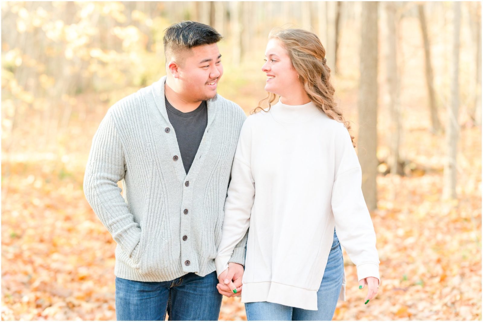 Couple walking holding hands Holcomb Gardens engagement session