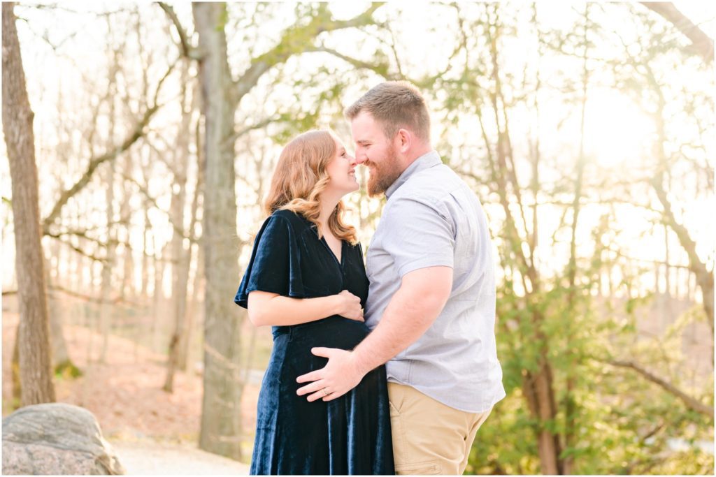 Husband and wife holding baby bump Holcomb Gardens maternity session