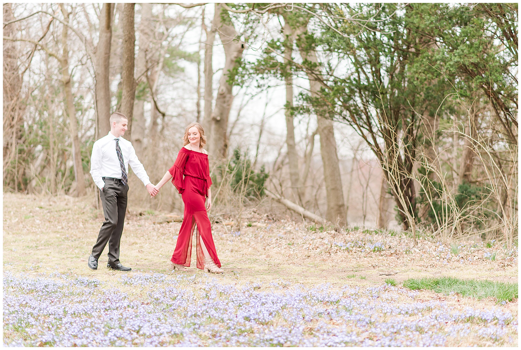 Bride in red dress, holding hands with groom and walking at Glenns Valley Nature Park