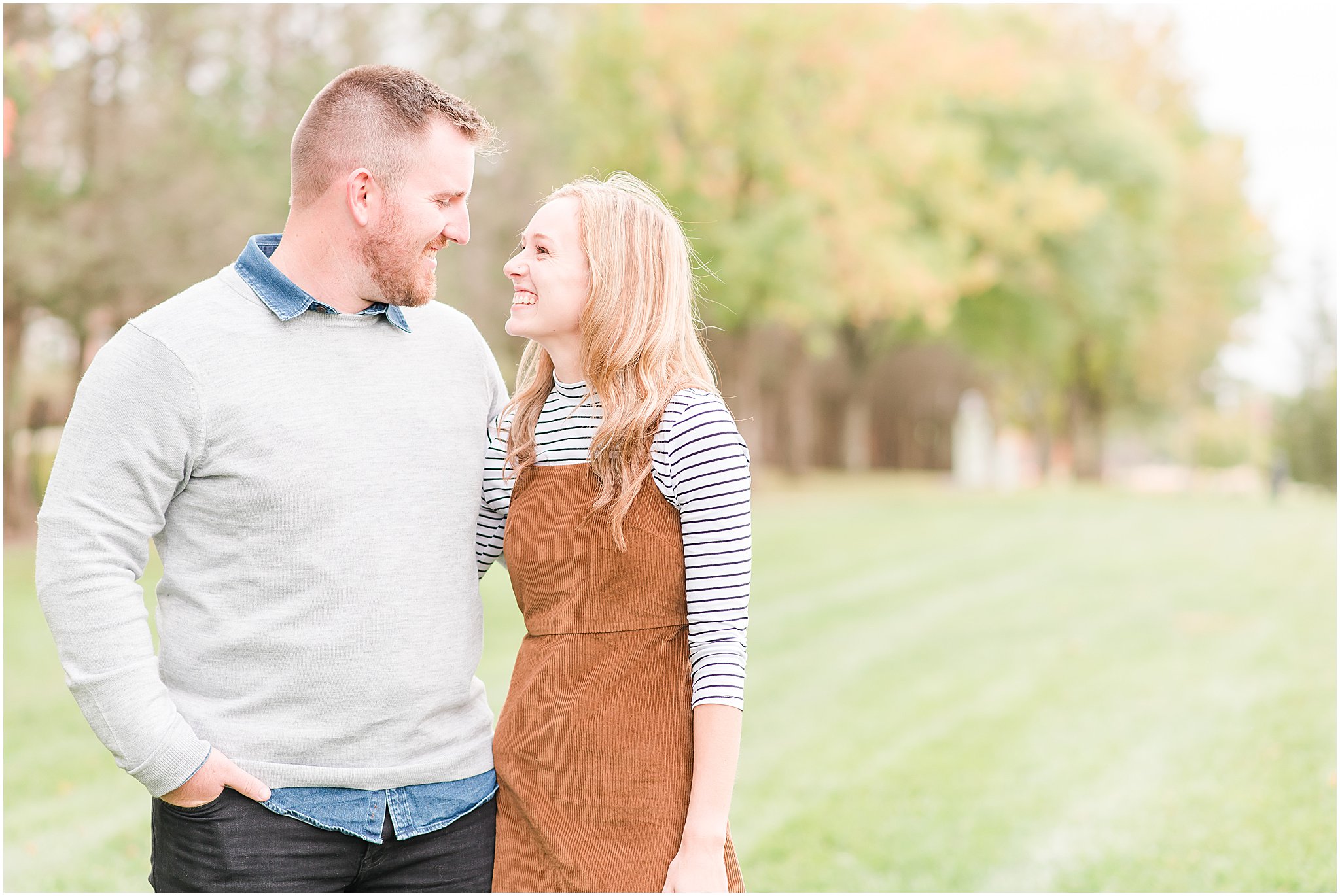 Man and woman smiling at each other during Coxhall Gardens engagement session