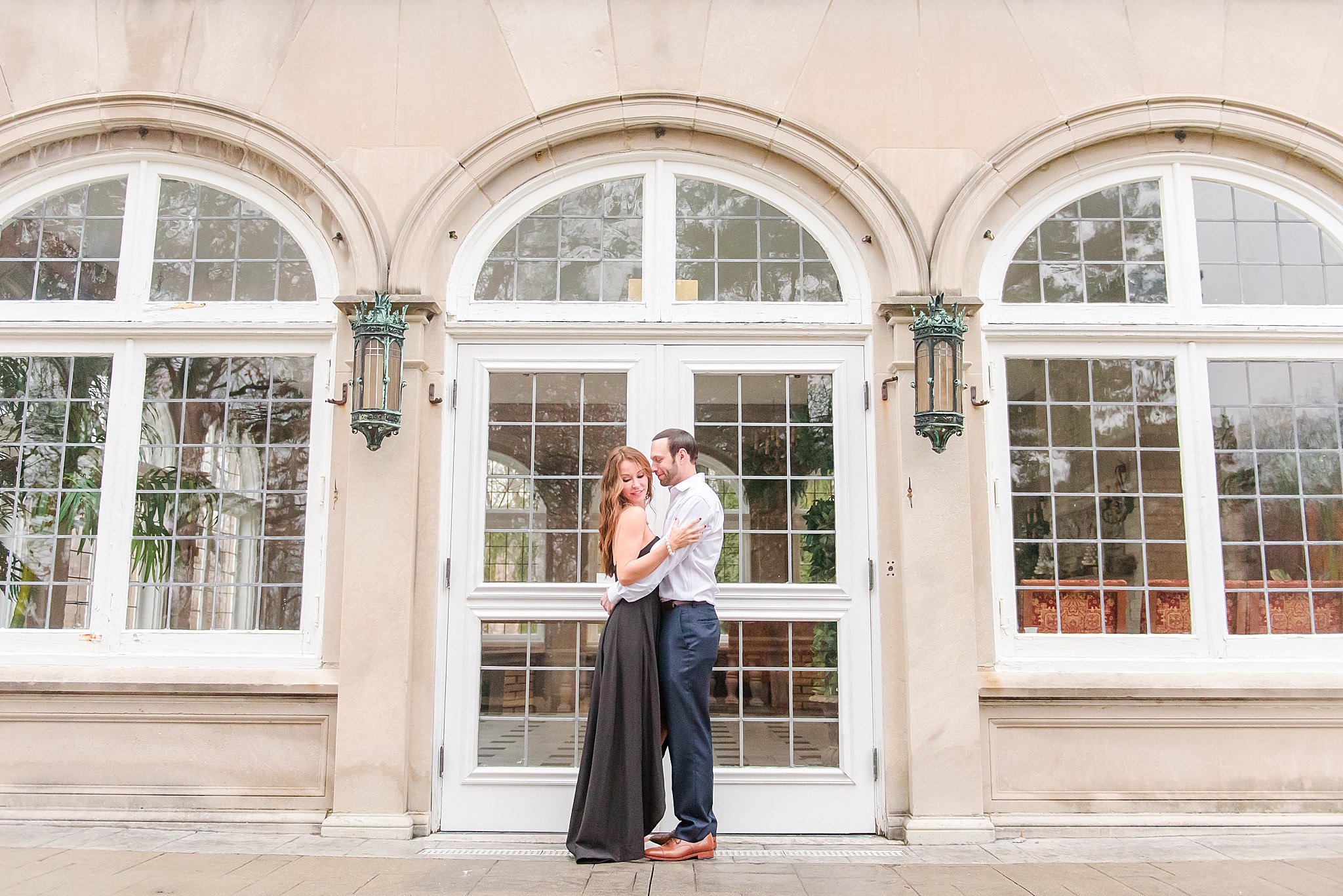 Couple nuzzling on patio during Laurel Hall Engagement Session
