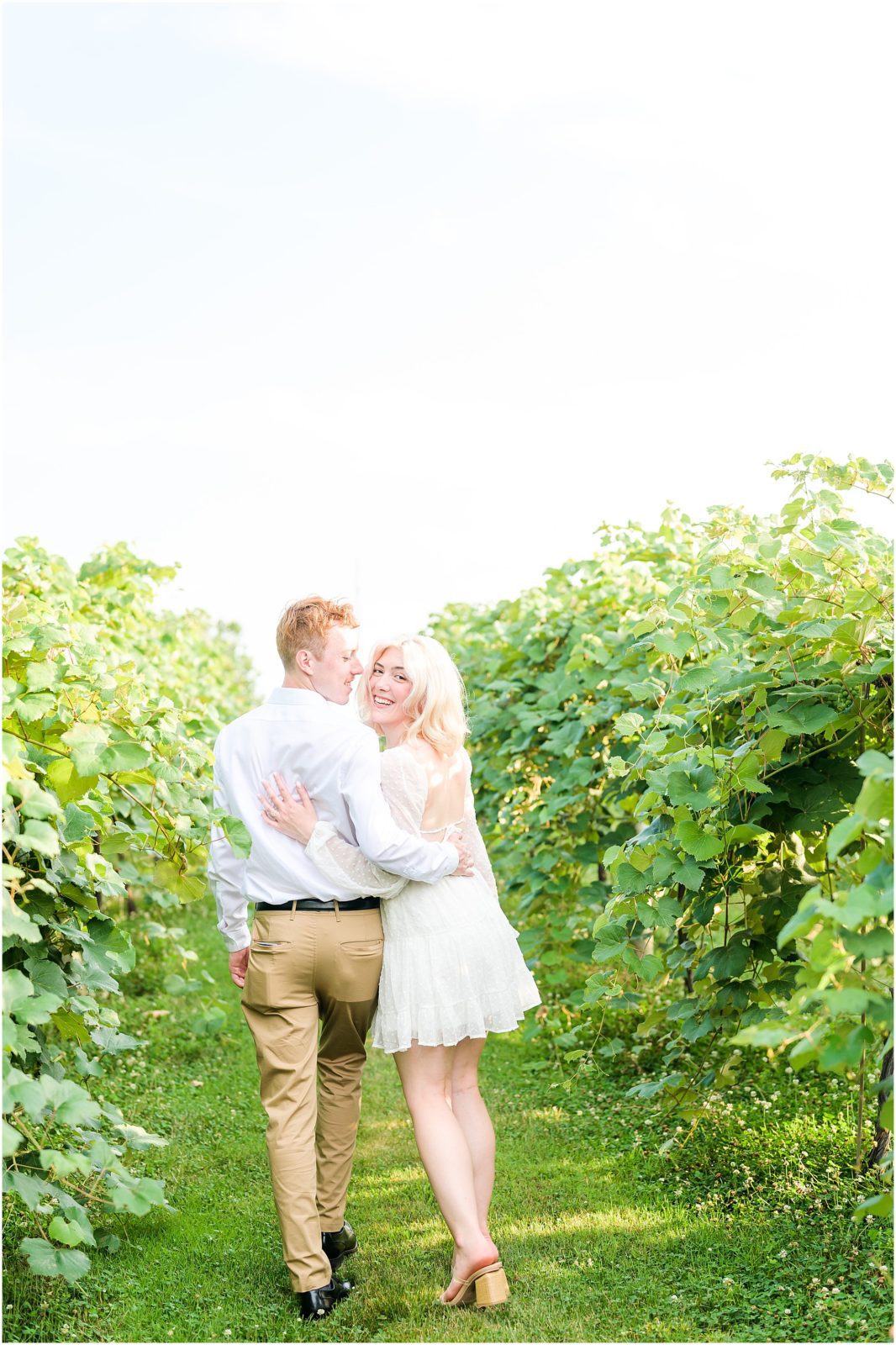 Couple walking and laughing together Oliver Winery engagement session